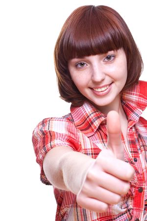 laughing girl in a shirt giving thumbs-up on a white backgroundの写真素材
