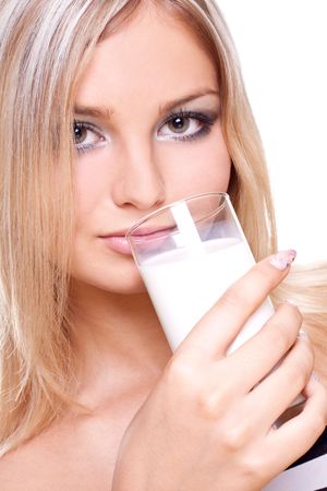 beautiful woman drinking milk on a white backgroundの写真素材