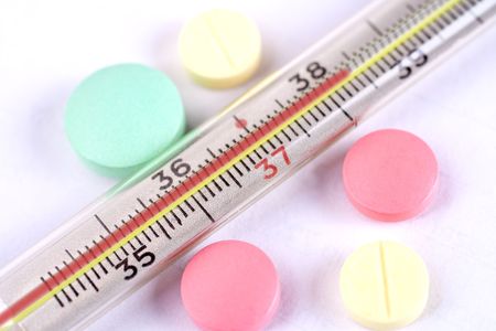thermometer and pills as a backgroundの写真素材