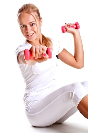 pink dumbbells in the hands of women on a white backgroundの写真素材