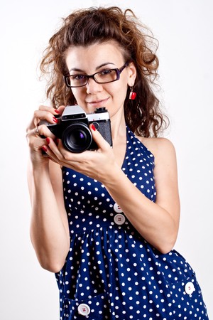 beautiful woman in a blue polka dot dress with cameraの写真素材