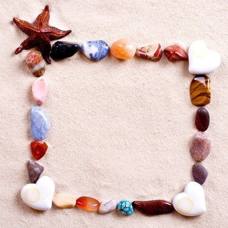 frame of shells in sand as a backgroundの写真素材