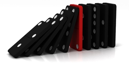 black dominoes falling over on a white backgroundの写真素材
