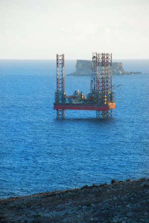 An Oil rig off the Coast of Wied Iz-Zurrieq with Filfla in the backgroundの写真素材
