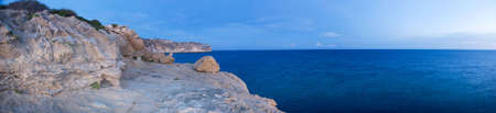 A panoramic view of the coast with the majestic cliffs on the left handside of the image looking on to the expansive seaの写真素材
