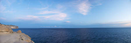 A panoramic view of the coast with the majestic cliffs on the left handside of the image looking on to the expansive seaの写真素材