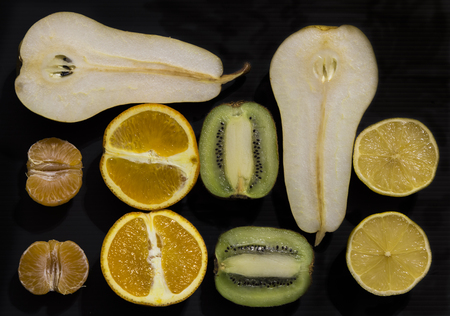 pieces of orange, lemon, kiwi, mandarin and pearの写真素材