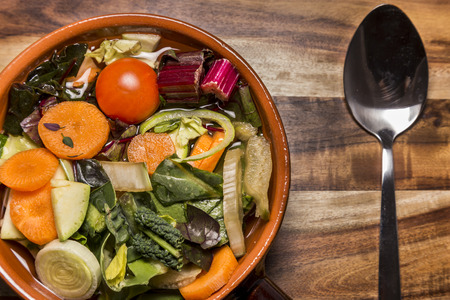 Italian vegetable minestrone soup with potatoes, carrots, onion, potatoes and breadの写真素材