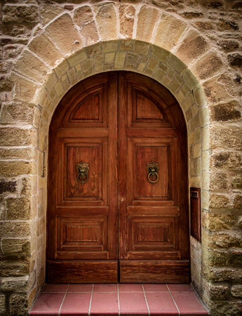 Old wooden door on a brick wallの写真素材