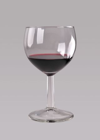 Glass of red wine on clear grey background, view from profileの写真素材