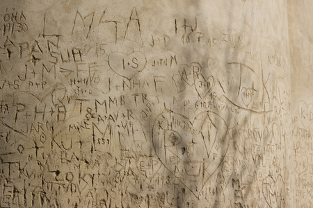 Lover's initials inside heart scratched on the old wallの写真素材