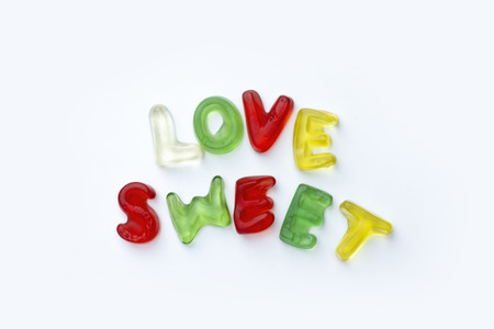 Title made from gummy letters of latin alphabet on white backgroundの写真素材