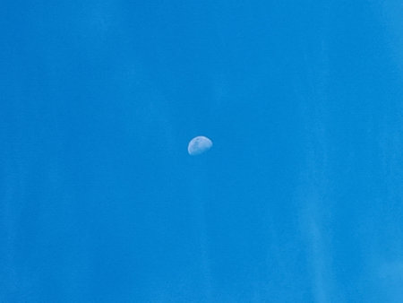 The moon in the blue sky. Blue sky and white clouds.の写真素材
