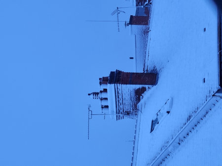 roofs and chimneys in winter, closeup of photoの写真素材