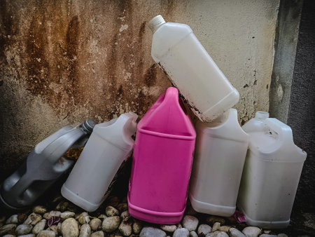 Plastic canister for gasoline and other household chemicals on concrete backgroundの写真素材
