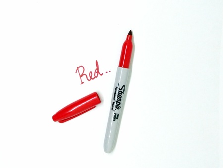 Red marker pen on isolated white background. Red marker pen that used to draw on presentation paper.のeditorial素材