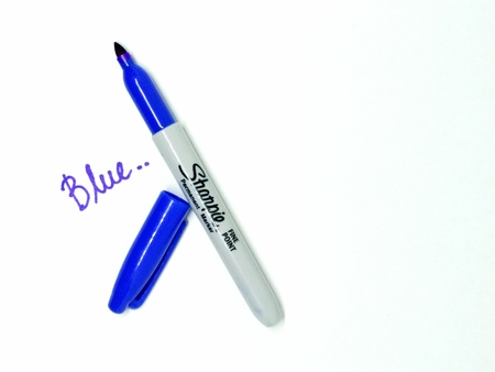 Blue marker pen on isolated white background. Blue marker pen that used to draw on presentation paper.のeditorial素材