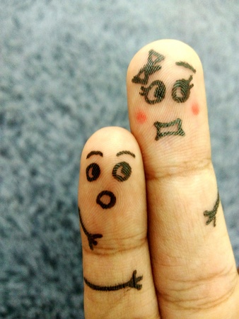 Two siblings finger art of sister and little brother with shocked face when they see somethingの写真素材