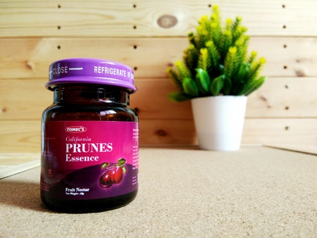 KUALA LUMPUR, MALAYSIA - OCTOBER 15, 2018 : Prunes essence in labelled bottles on wooden pallet.のeditorial素材