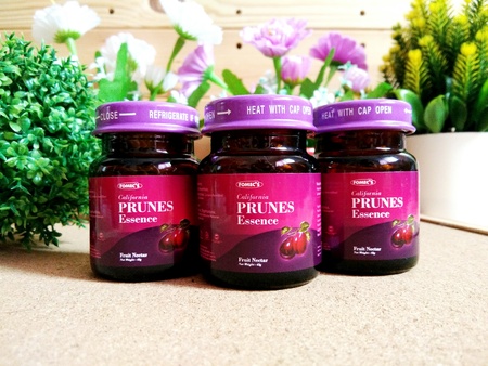 KUALA LUMPUR, MALAYSIA - OCTOBER 15, 2018 : Prunes essence in labelled bottles on wooden pallet.のeditorial素材