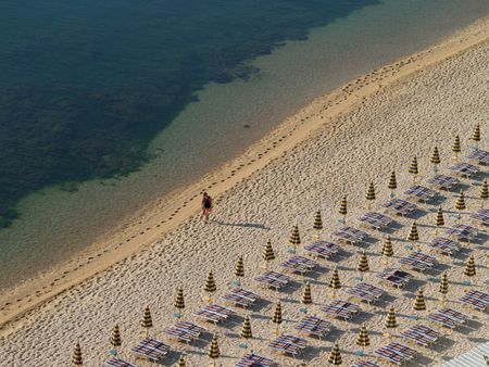 early morning walk on the beach, numana, italy