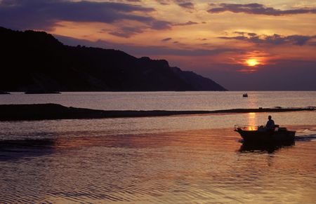  boat coming back at sunsetの写真素材