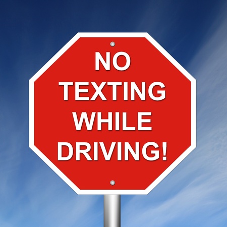 No Texting While Driving Sign mounted on pole with sky background.の写真素材
