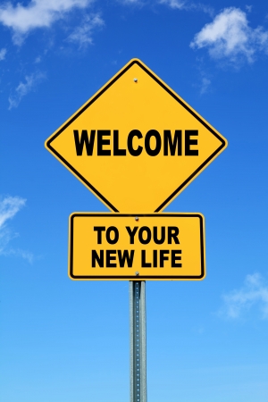 Yellow motivational road sign Welcome to your new lifeの写真素材