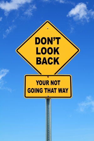 Yellow motivational road sign don t look backの写真素材