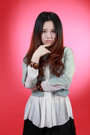 A Beautiful Chinese girl Isolated On red.の写真素材