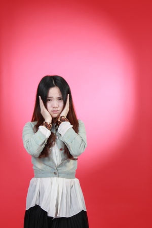 A Beautiful Chinese girl Isolated On red.の写真素材