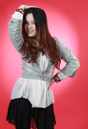 A Beautiful Chinese girl Isolated On red.の写真素材