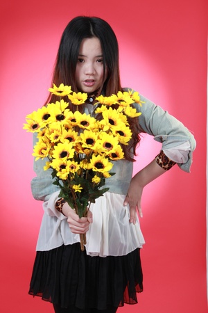 A Beautiful Chinese girl with many flowers.の写真素材