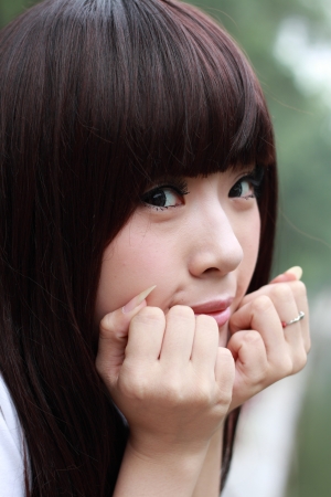 A lovely asian woman in a park.の写真素材