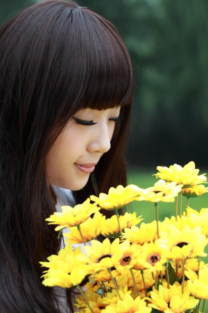 A lovely asian woman in a park の写真素材