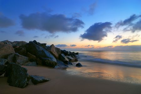 Morning long exposure on the beach near a seawall.の写真素材