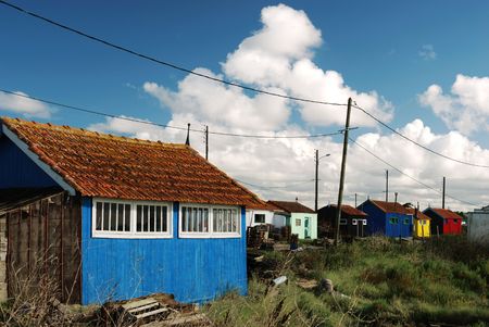 Multicolored shacks and wires near the ocean coast (Oleron / France)の写真素材