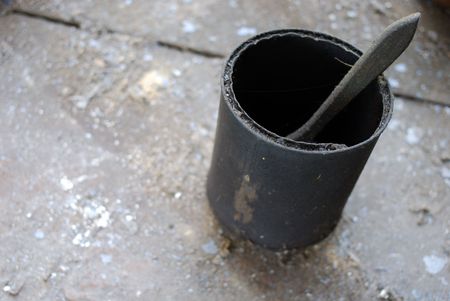 Grunge paintbrush in an old bucket