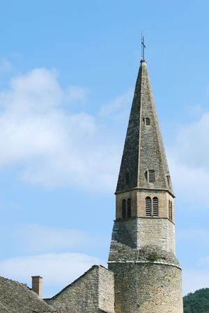 Medieval church steeple against blue sky in Cremieu (IsÃƒÂ¨re / France)