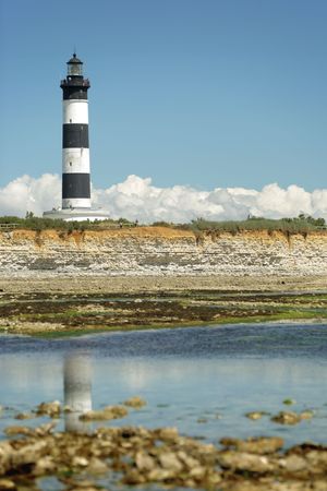 Low tide view of the Chassiron's lighthouse in Oleron island.の写真素材