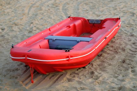 Red boat on the sand of the beachの写真素材