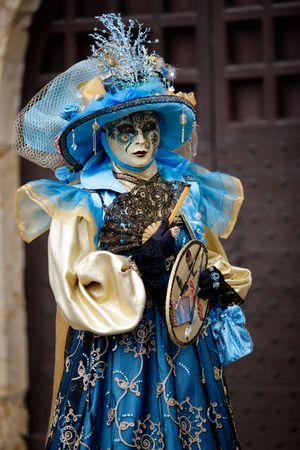 Woman carnival mask dressed in blue and gold (Annecy/France)の写真素材
