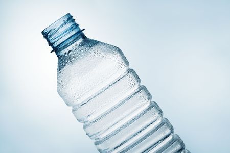 Isolated tilt plastic water bottle with blue tintの写真素材