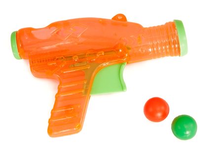 Orange plastic gun with bullets isolated on a white backgroundの写真素材