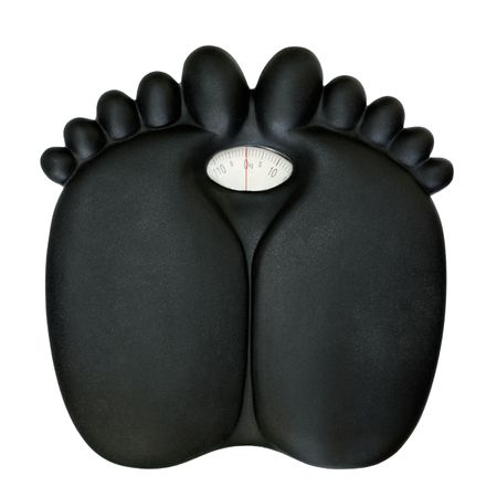 A bathroom scale feet shaped isolated on a white background with soft shadowsの写真素材