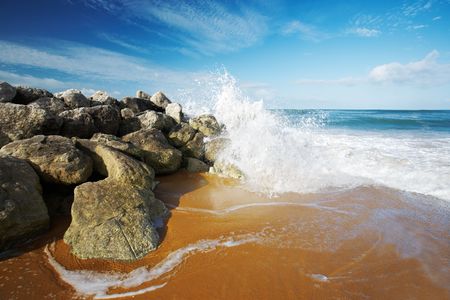 Wide angle and polarized view of a wave splashing on a seawall.の写真素材