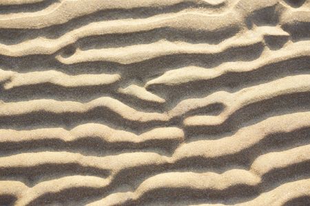 Sand texture background due to wind and water の写真素材