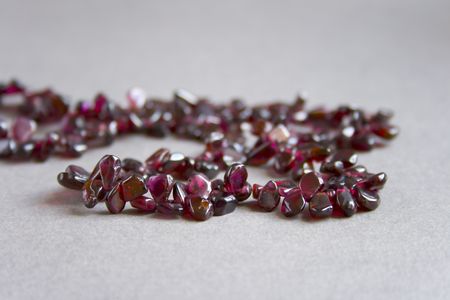 Pomegranate beads on the grey