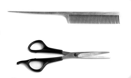 Scissors and hairbrush isolated on white
