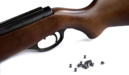Part of an pneumatic rifle and bullet on a white backgroundの写真素材